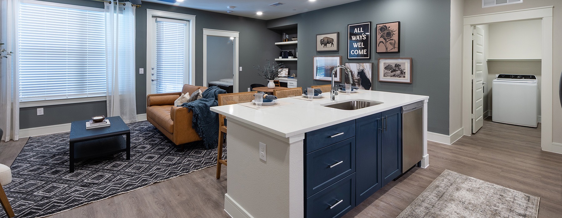 a kitchen island with a sink and dishwasher