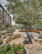 a courtyard with chairs and tables and trees