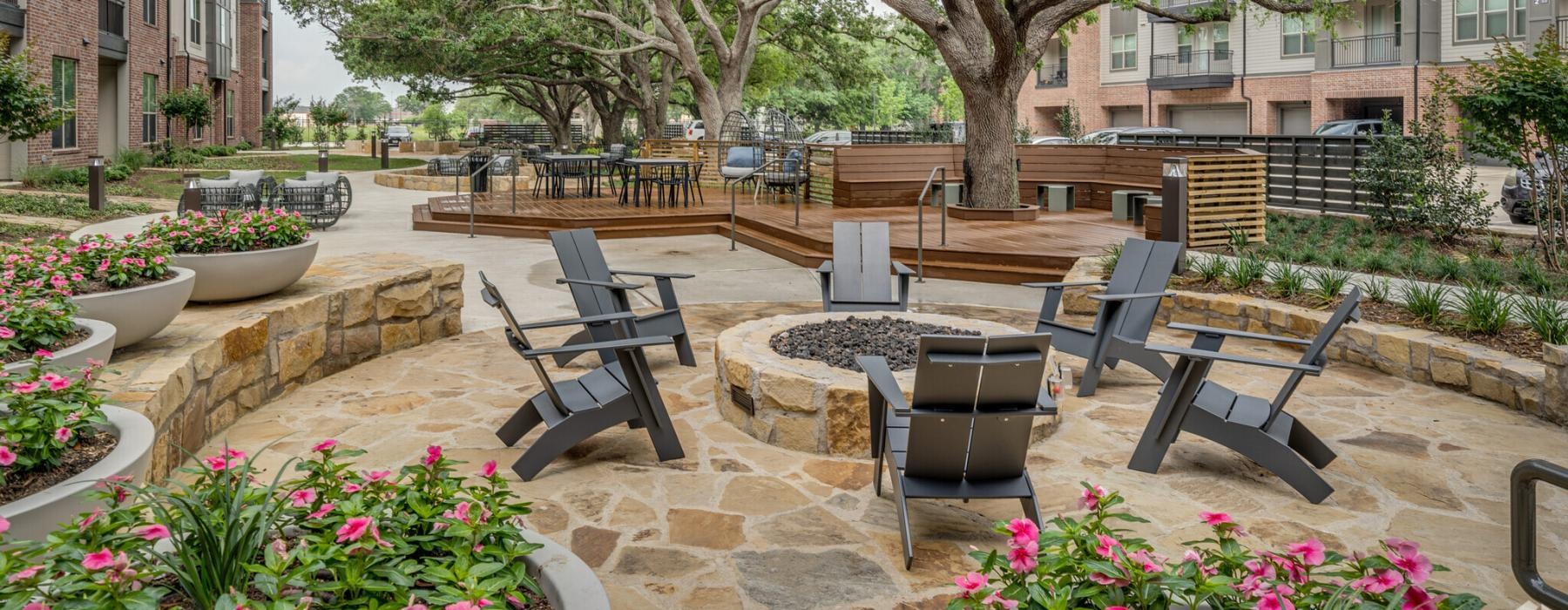 a courtyard with chairs and tables and trees