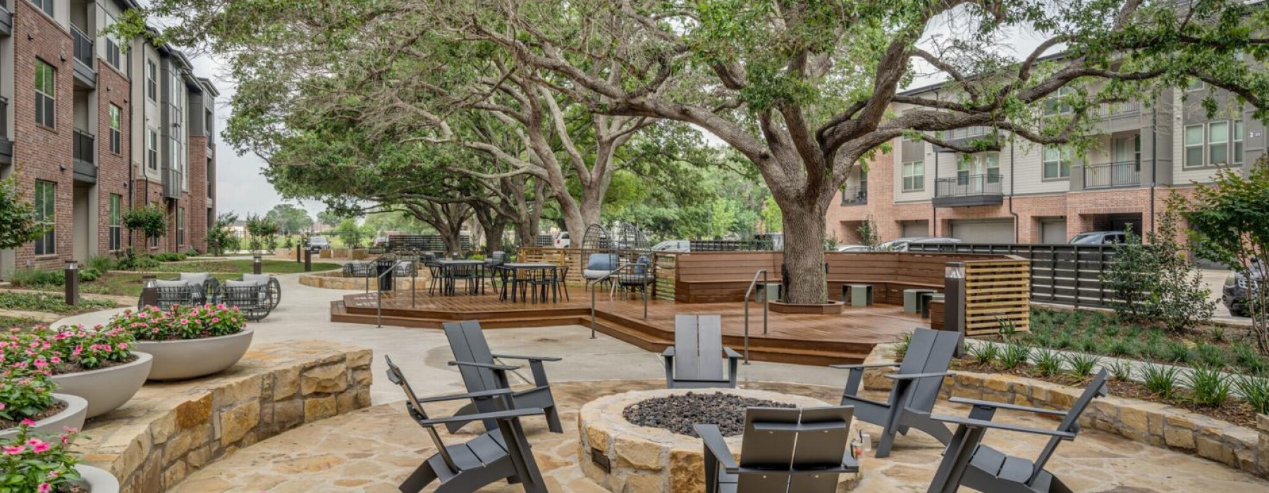 a courtyard with chairs and tables and trees